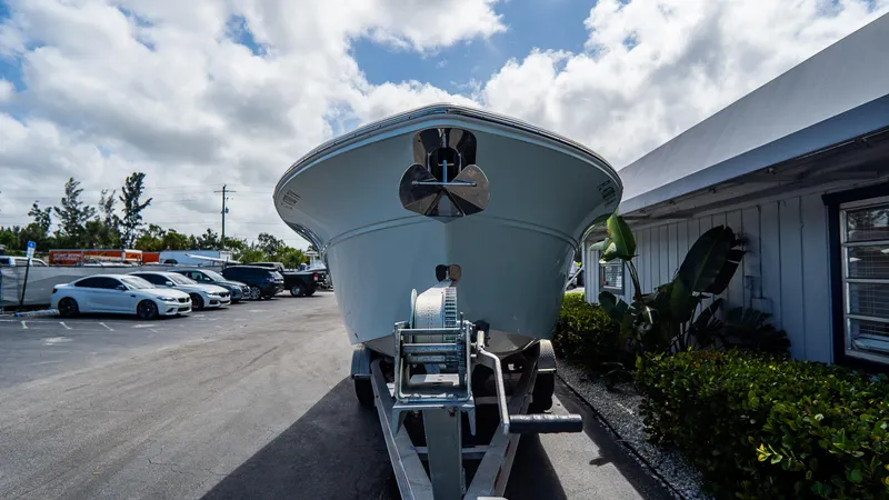 Slide: The Image of 2024 Sea Fox 268 Commander boat on trailer, parked outdoors under cloudy sky. - 3