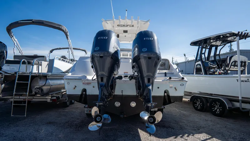 Slide: The Image of 2024 Sea Fox 268 Commander with dual outboard engines, displayed in a boatyard. - 4