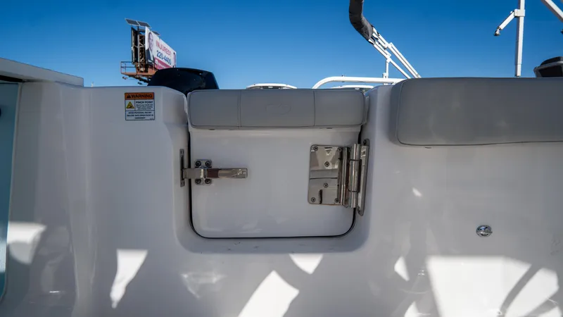 Slide: The Image of 2024 Sea Fox 268 Commander boat interior with cushioned seating and secure latch. - 40