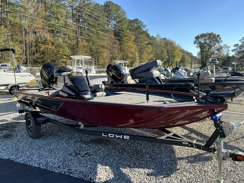 Slide: The Image of 2025 Lowe Stinger ST175 boat on trailer, parked outdoors. - 4