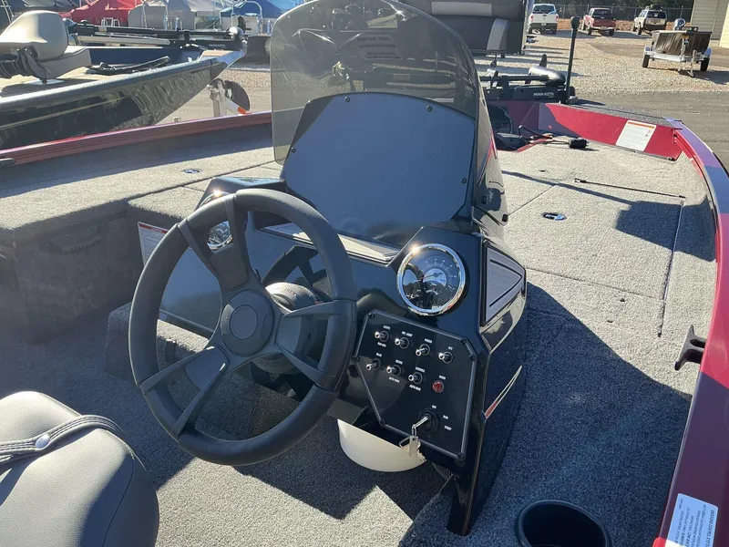 Slide: The Image of 2025 Lowe Stinger ST175 boat dashboard with steering wheel and control panel. - 9