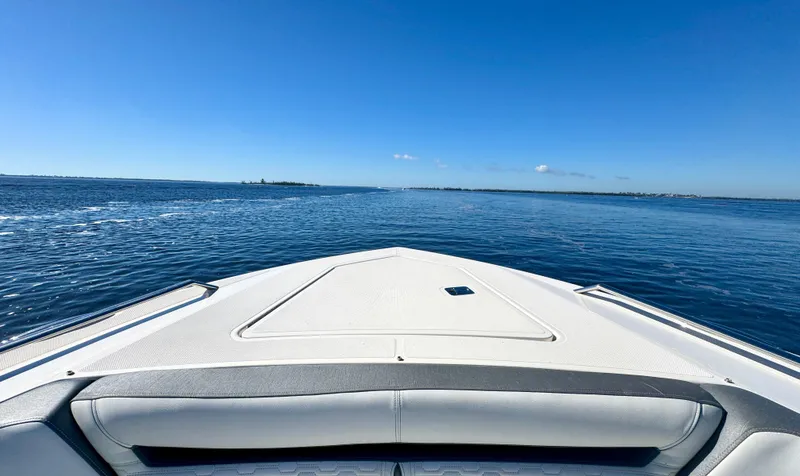 Slide: The Image of Bow view of 2018 Tiara Yachts 38 LS on open water under clear blue sky. - 10