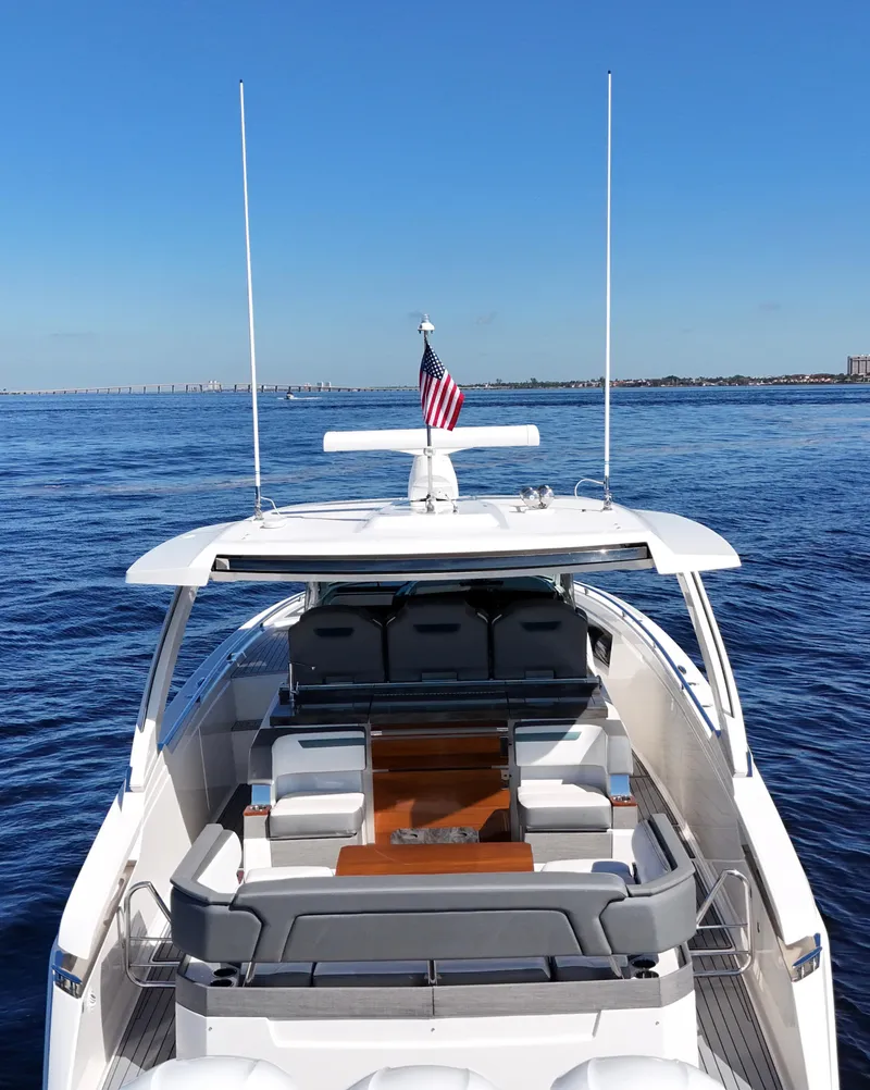 Slide: The Image of 2018 Tiara Yachts 38 LS on open water, featuring sleek design and spacious seating. - 15