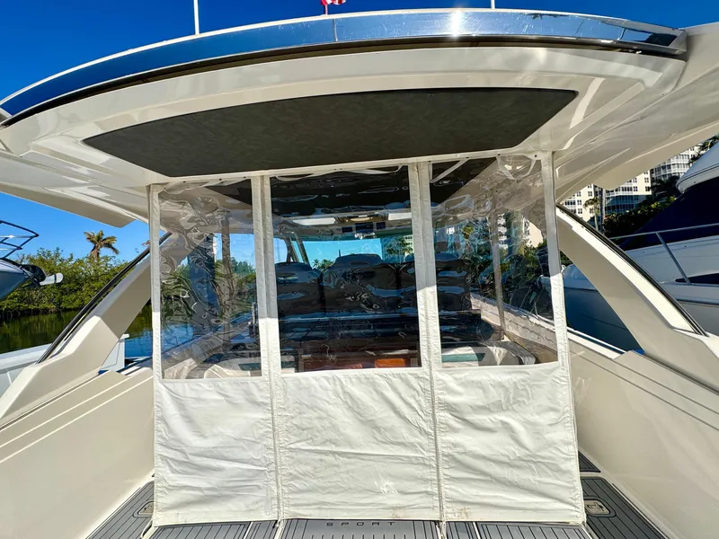 Slide: The Image of 2018 Tiara Yachts 38 LS with covered cockpit, docked under clear blue sky. - 22