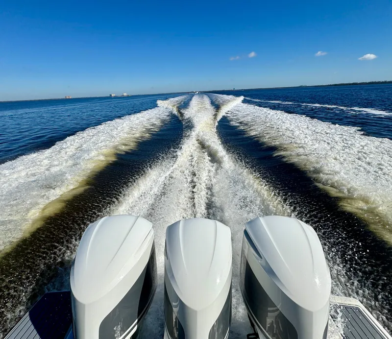 Slide: The Image of Tiara Yachts 38 LS 2018 cruising, leaving a wake on open water under clear blue skies. - 23