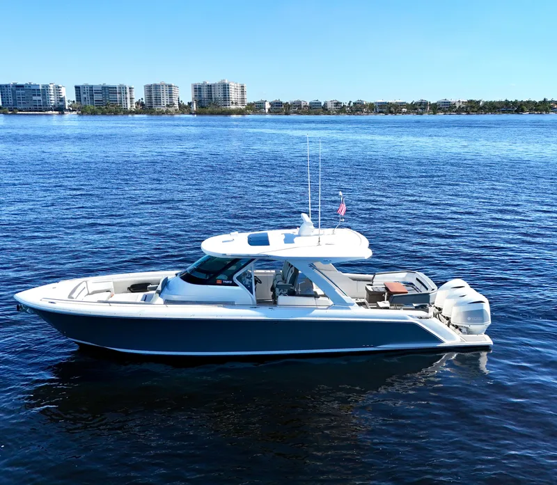 Slide: The Image of 2018 Tiara Yachts 38 LS on calm water with city skyline background. - 25
