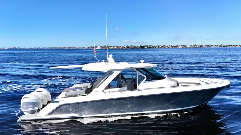 Slide: The Image of 2018 Tiara Yachts 38 LS cruising on open water under clear blue skies. - 30