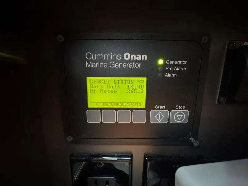 Slide: The Image of Cummins Onan marine generator display on 2018 Tiara Yachts 38 LS, showing battery voltage. - 31