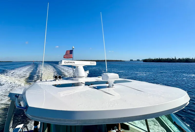 Slide: The Image of Tiara Yachts 38 LS 2018 cruising on open water under clear blue sky. - 32