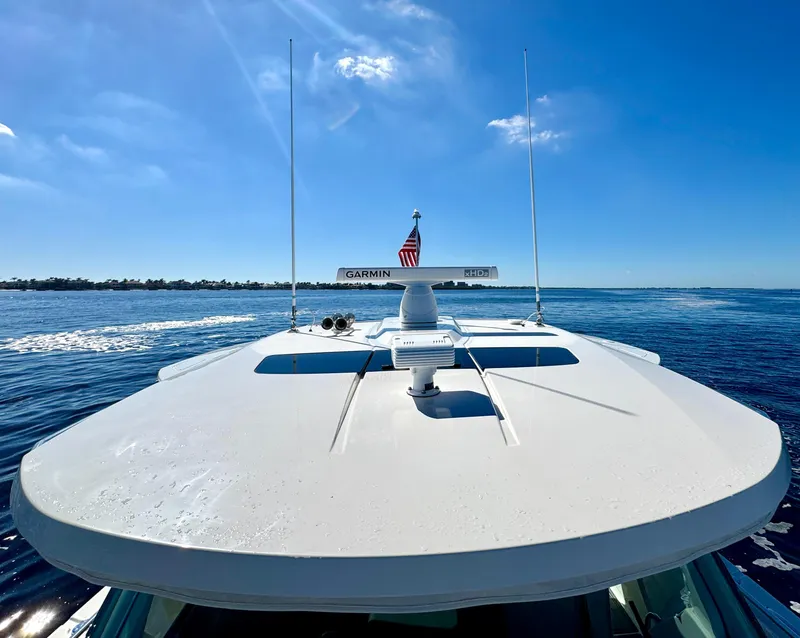 Slide: The Image of Tiara Yachts 38 LS 2018 cruising on a sunny day with clear blue skies. - 33