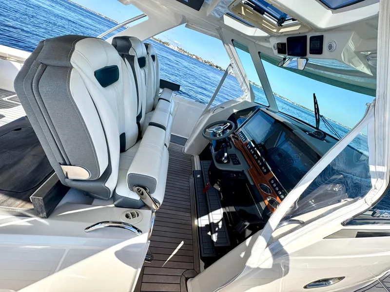 Slide: The Image of Interior of 2018 Tiara Yachts 38 LS, featuring luxurious seating and modern dashboard. - 37
