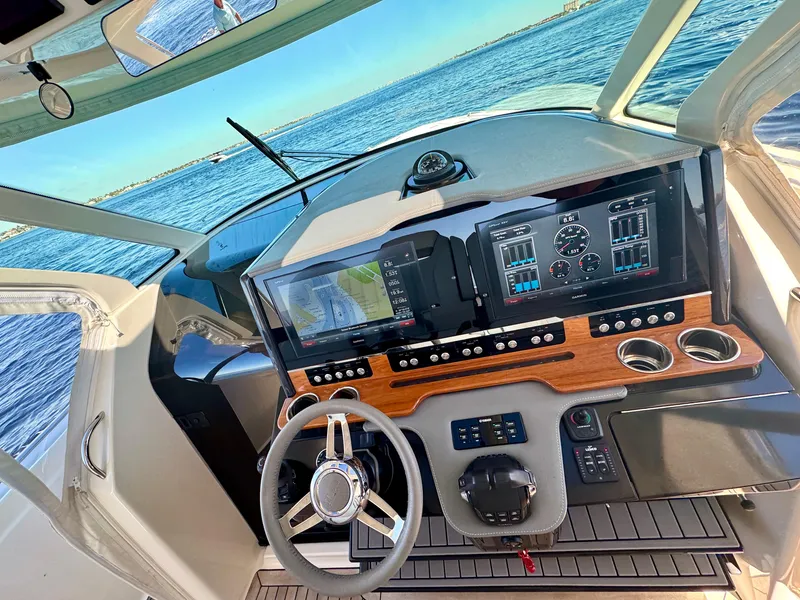 Slide: The Image of Cockpit of 2018 Tiara Yachts 38 LS with advanced navigation displays and steering wheel. - 41
