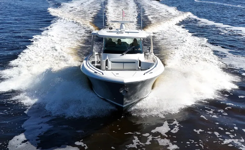 Slide: The Image of 2018 Tiara Yachts 38 LS cruising on open water, creating a dynamic wake. - 9