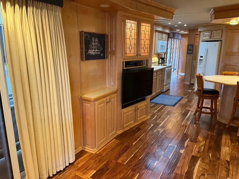 Slide: The Image of Luxurious 2001 Sharpe 75 interior with wood flooring, modern kitchen, and elegant cabinetry. - 10