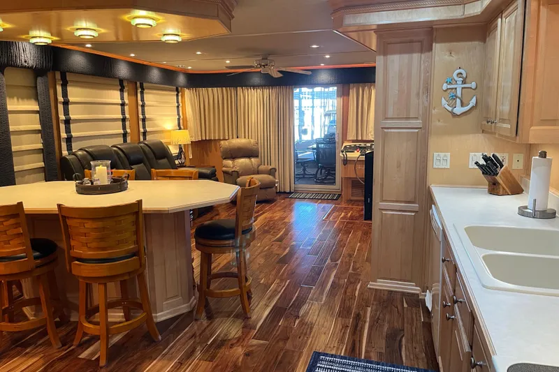 Slide: The Image of Luxurious 2001 Sharpe 75 houseboat interior with wood flooring and modern furnishings. - 14