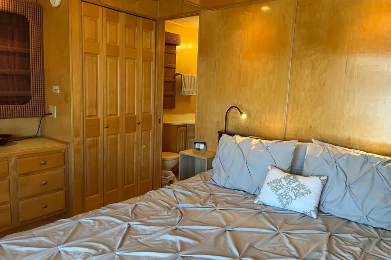 Slide: The Image of Cozy bedroom with wooden decor, soft bedding, and ambient lighting in a 2001 Sharpe model 75. - 32