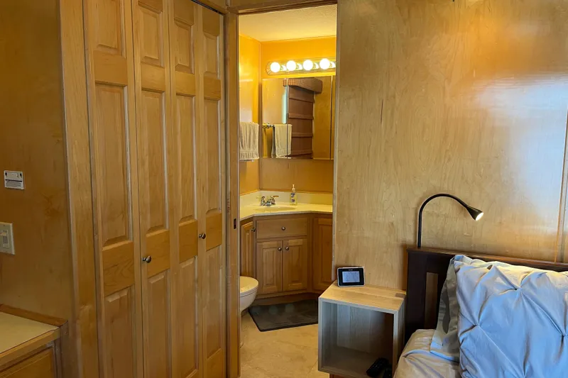 Slide: The Image of Cozy bedroom with wooden decor, adjacent bathroom, and soft lighting in a 2001 Sharpe model 75. - 36