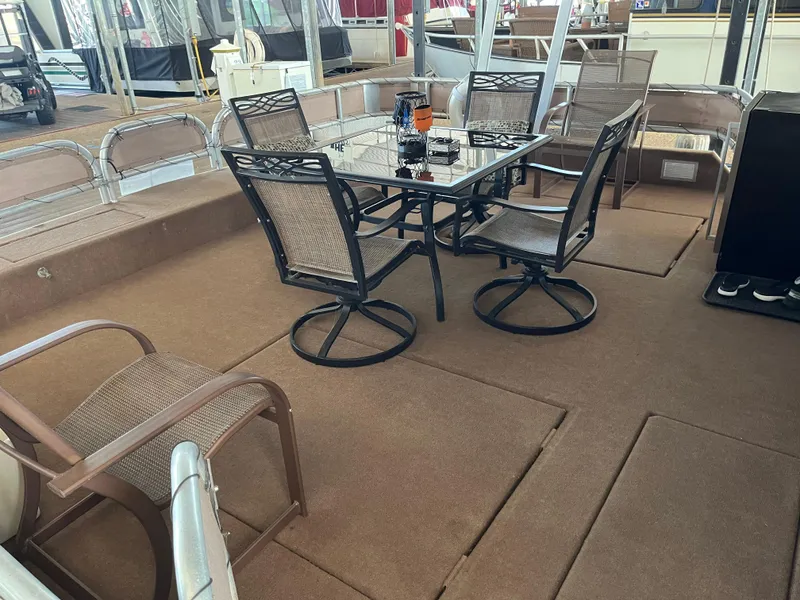 Slide: The Image of Outdoor seating area on a 2001 Sharpe 75 houseboat with glass table and chairs. - 4