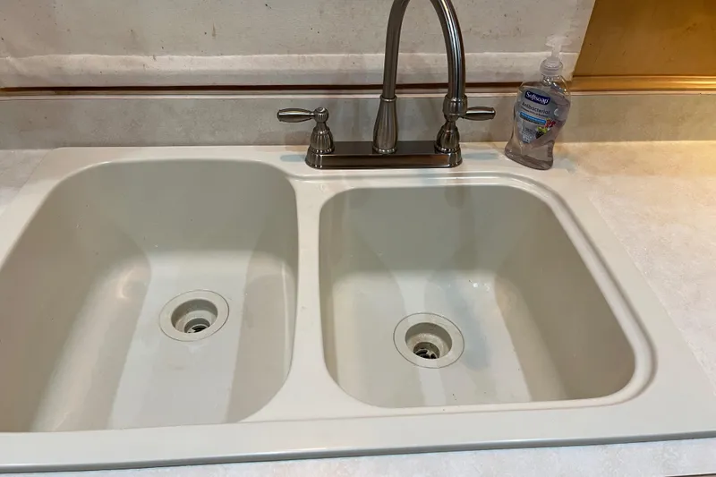 Slide: The Image of Double kitchen sink with faucet and soap bottle, Sharpe model 75, 2001. - 41