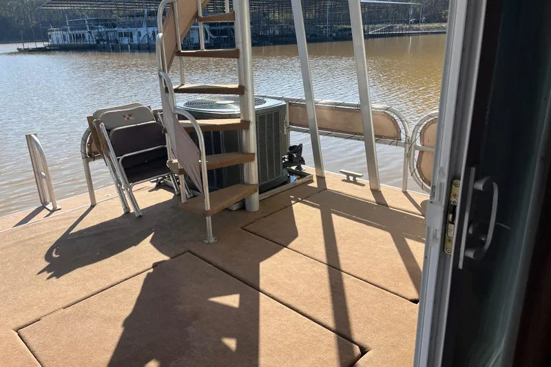 Slide: The Image of Houseboat deck with spiral staircase, chairs, and water view; Sharpe 75, 2001 model. - 42