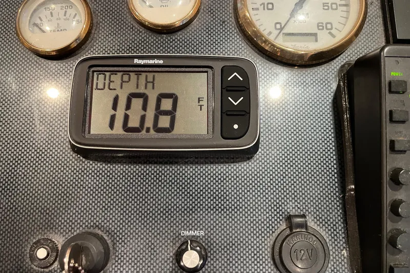 Slide: The Image of Boat dashboard with depth gauge reading 10.8 feet, Sharpe 75 model, 2001. - 47