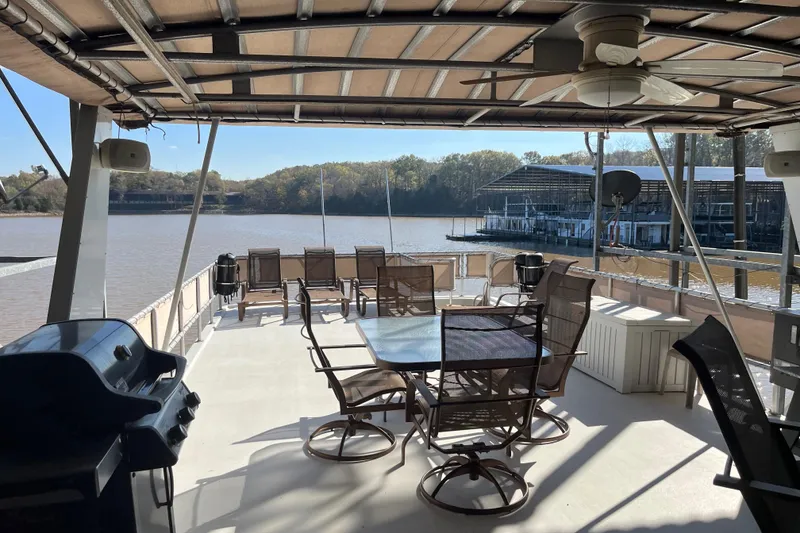 Slide: The Image of Houseboat deck with seating, grill, and scenic lake view; Sharpe 75, 2001 model. - 48