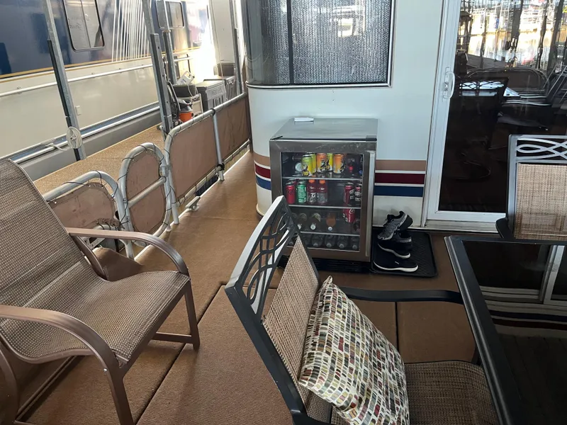 Slide: The Image of Houseboat deck with chairs, mini fridge, and shoes; Sharpe 75, 2001 model. - 6