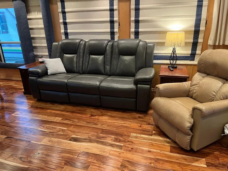 Slide: The Image of Luxurious living room with leather sofa, recliner, and wooden flooring in a Sharpe 75, 2001 model. - 8