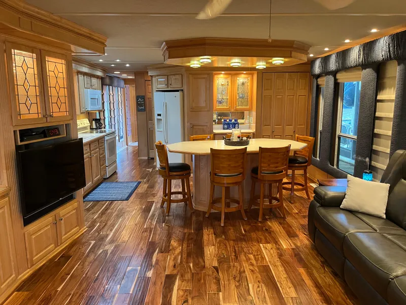 Slide: The Image of Luxurious 2001 Sharpe 75 houseboat interior with elegant wood flooring and modern kitchen. - 9