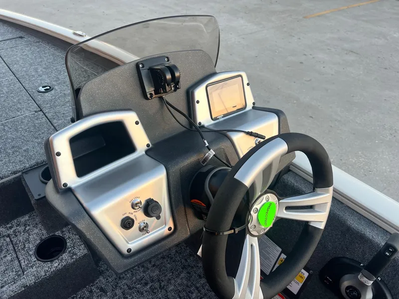 Slide: The Image of 2025 Tracker Pro Team 195 Tournament Edition boat dashboard with steering wheel and controls. - 6