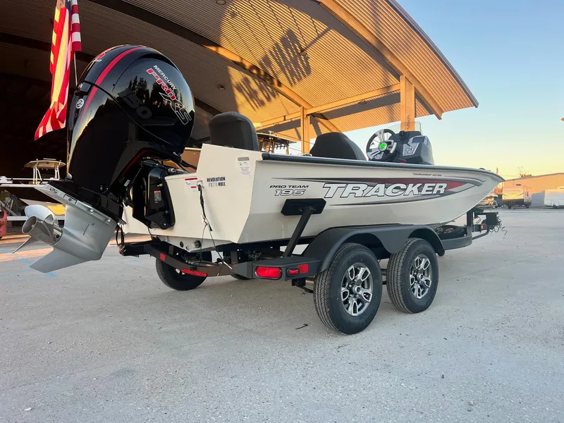 Slide: The Image of 2025 Tracker Pro Team 195 Tournament Edition boat on trailer, parked outdoors. - 9