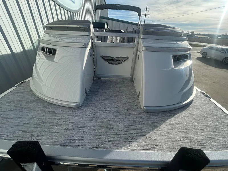 Slide: The Image of 2025 Bennington Q 27 pontoon boat, rear view, docked outdoors. - 4
