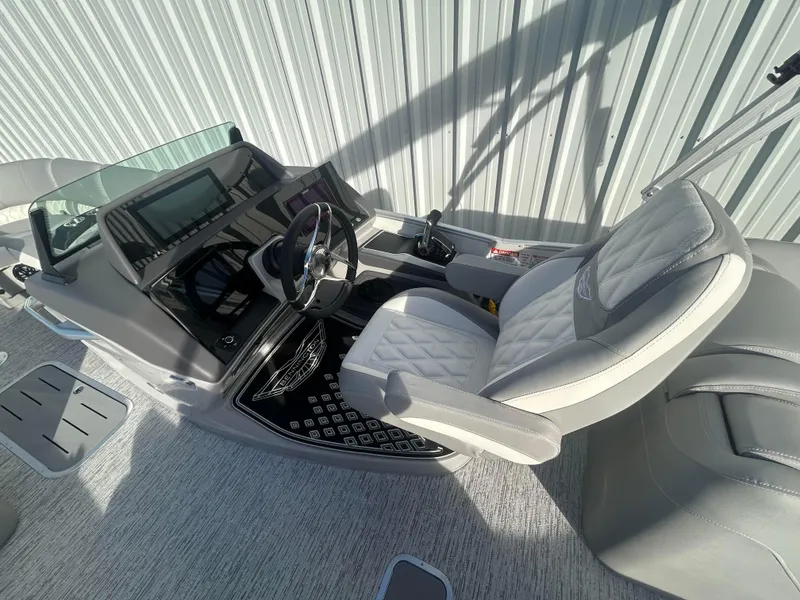 Slide: The Image of 2025 Bennington Q 27 boat interior with modern helm and luxurious seating. - 7