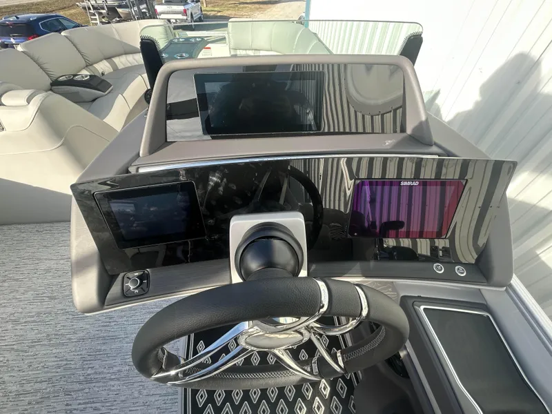 Slide: The Image of 2025 Bennington Q 27 boat dashboard with modern steering and digital displays. - 8