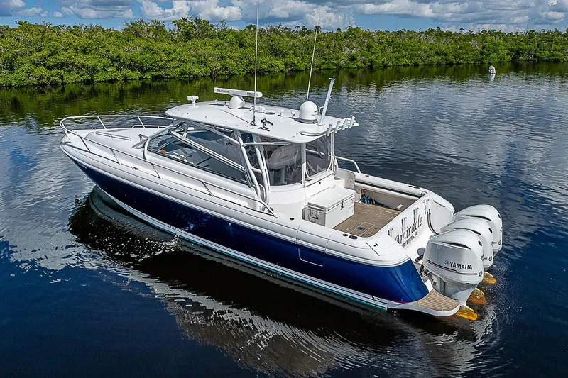 Slide: The Image of 2016 Intrepid 430 Sport Yacht on calm water, featuring sleek design and powerful engines. - 13