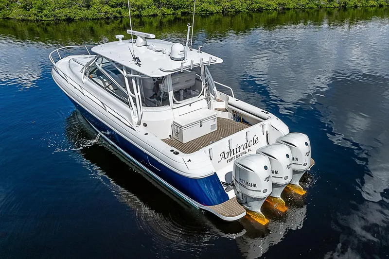 Slide: The Image of 2016 Intrepid 430 Sport Yacht with triple Yamaha engines on calm water. - 14