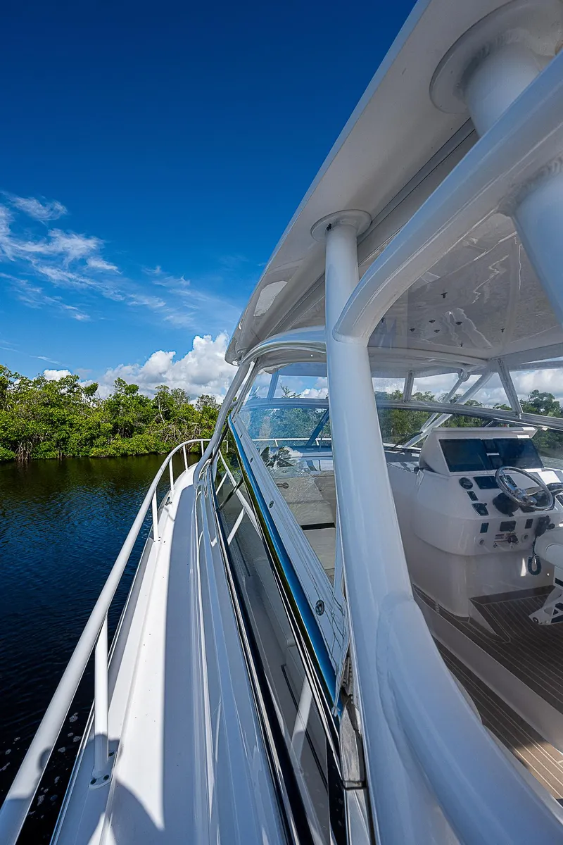 Slide: The Image of 2016 Intrepid 430 Sport Yacht on serene water, clear blue sky backdrop. - 16