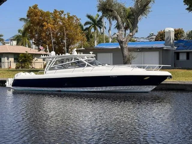 Slide: The Image of 2016 Intrepid 430 Sport Yacht docked by a waterfront home. - 2