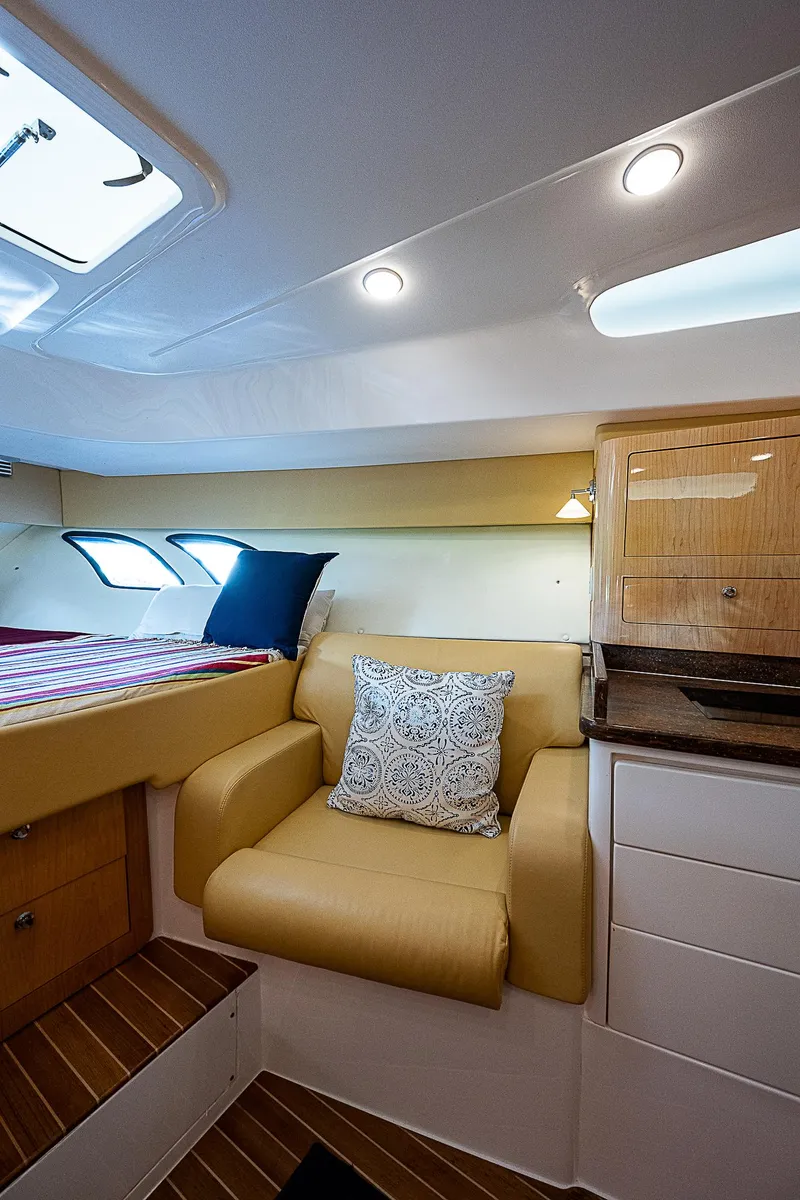 Slide: The Image of 2016 Intrepid 430 Sport Yacht interior with cozy seating and modern design. - 23