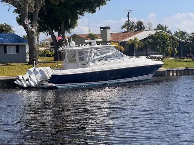 Slide: The Image of 2016 Intrepid 430 Sport Yacht docked by a waterfront home. - 3