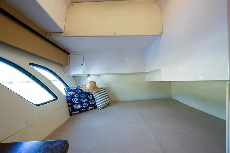 Slide: The Image of 2016 Intrepid 430 Sport Yacht interior cabin with cozy bedding and decorative pillows. - 32