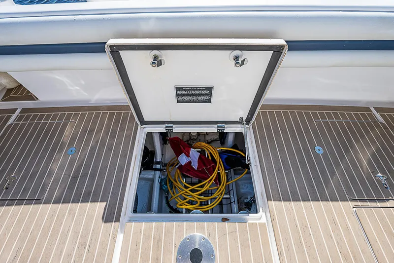Slide: The Image of Open storage compartment on 2016 Intrepid 430 Sport Yacht deck with coiled cables. - 41