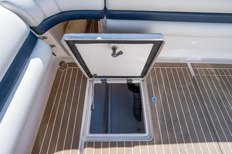 Slide: The Image of Open hatch on 2016 Intrepid 430 Sport Yacht deck, revealing storage compartment. - 42