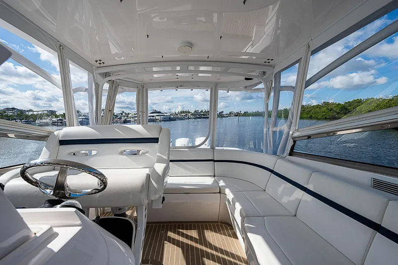 Slide: The Image of Interior view of 2016 Intrepid 430 Sport Yacht, featuring luxurious seating and panoramic windows. - 46