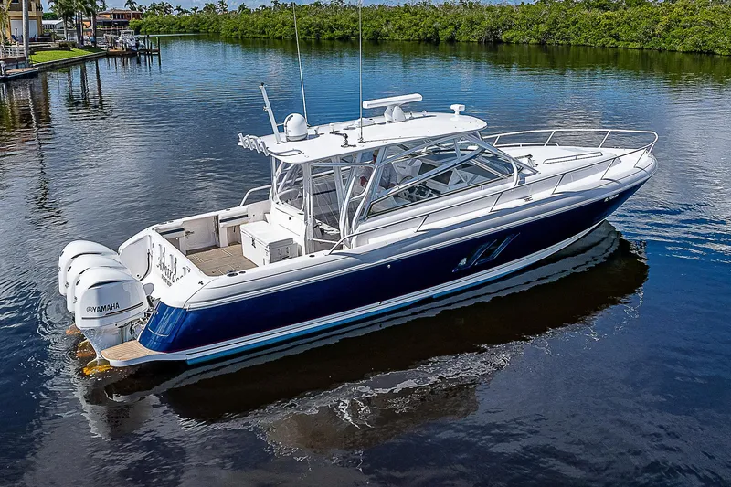 Slide: The Image of 2016 Intrepid 430 Sport Yacht on calm water, showcasing sleek design and powerful engines. - 5