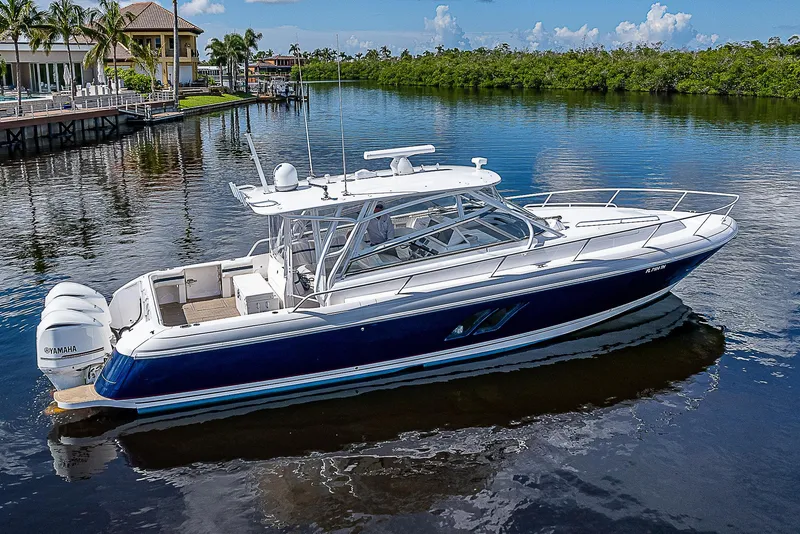Slide: The Image of 2016 Intrepid 430 Sport Yacht on calm water, showcasing sleek design and powerful engines. - 6