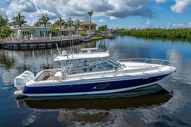 Slide: The Image of 2016 Intrepid 430 Sport Yacht on calm water, surrounded by tropical scenery. - 7