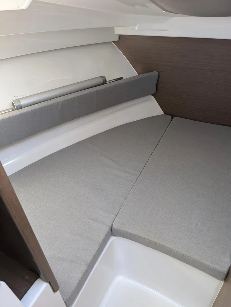 Slide: The Image of 2020 Jeanneau NC 795 cabin interior with gray cushions and modern design. - 23