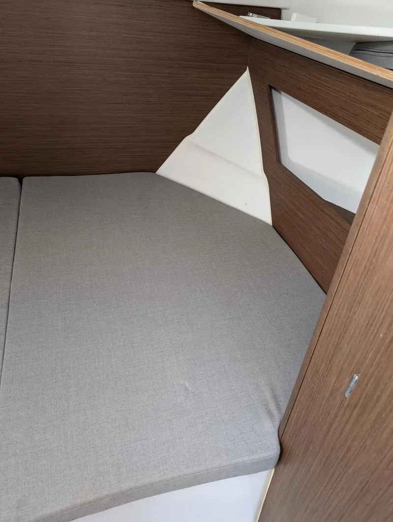 Slide: The Image of Interior cabin of 2020 Jeanneau NC 795 with cozy bed and wooden finish. - 24