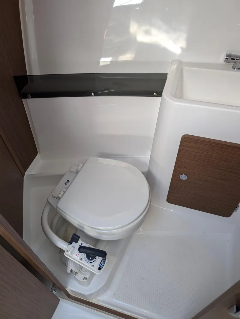 Slide: The Image of Compact bathroom in 2020 Jeanneau NC 795 boat with toilet and sink. - 25